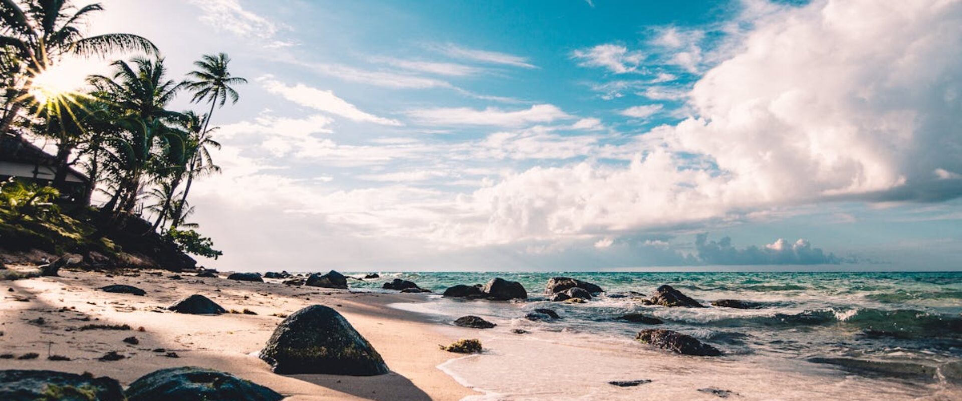 Experience the serene beauty of a tropical beach in RAAS, Nicaragua, with palm trees and ocean waves.