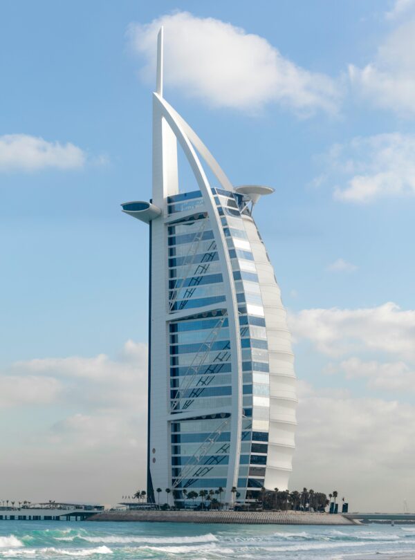 Stunning view of the iconic Burj Al Arab hotel against a clear blue sky in Dubai, UAE.
