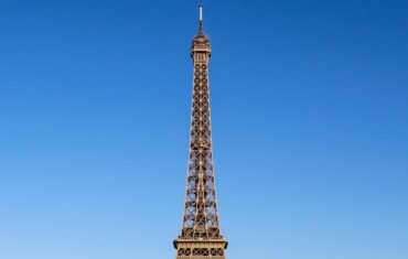 Stunning daylight shot capturing the Eiffel Tower with clear blue skies in Paris.