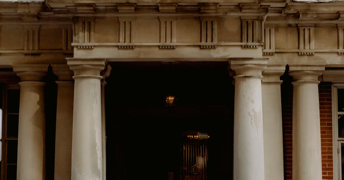 A group of people gathered outside a Canadian embassy entrance featuring a prominent flag.